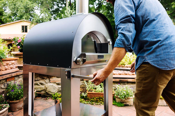 https://www.fontanaforniusa.com/cdn/shop/articles/man-using-his-new-hybrid-pizza-oven-from-fontana-forni_720x720.png?v=1694446288